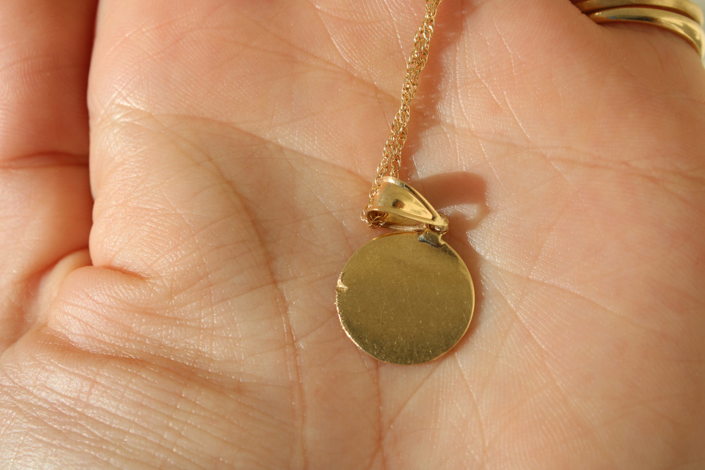 A classic and nostalgic vintage 14k gold angel charm of an adorable cherub that can be the sweetest reminder of a babe for a new mom, grandmother or other family member, or given to a babe as a christening gift.