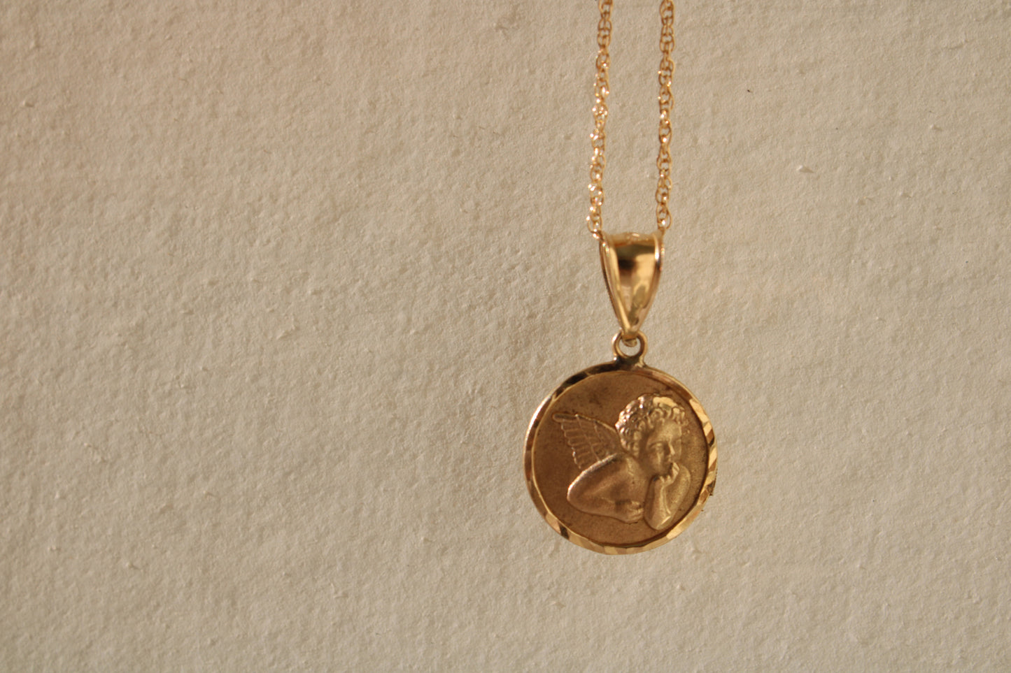 A classic and nostalgic vintage 14k gold angel charm of an adorable cherub that can be the sweetest reminder of a babe for a new mom, grandmother or other family member, or given to a babe as a christening gift.