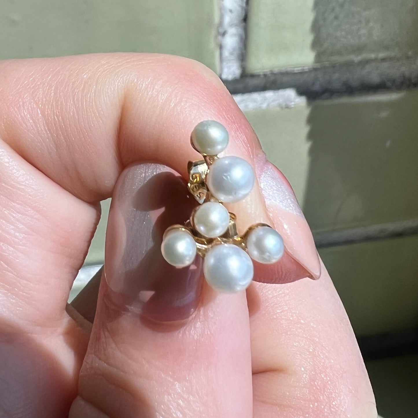 Six lustrous freshwater cultured pearls set in 14k gold. The largest pearl is 4mm and is hugged by two 3mm pearls. Earring posts have two friction groves to provide extra security and durability to hold the earring backs in place.