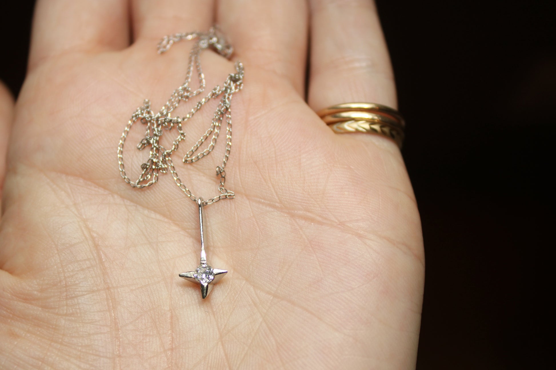 The *only* white gold necklace I have in my current collection. This beautifully delicate cable chain is balanced with an expertly set colorless CZ pendant.  Details: - process: I found this chain as part of an estate sale I was exploring.  - materials: 14k solid white gold (hallmarked) + CZ pendant (20mm long x 5mm wide)