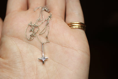 The *only* white gold necklace I have in my current collection. This beautifully delicate cable chain is balanced with an expertly set colorless CZ pendant.  Details: - process: I found this chain as part of an estate sale I was exploring.  - materials: 14k solid white gold (hallmarked) + CZ pendant (20mm long x 5mm wide)
