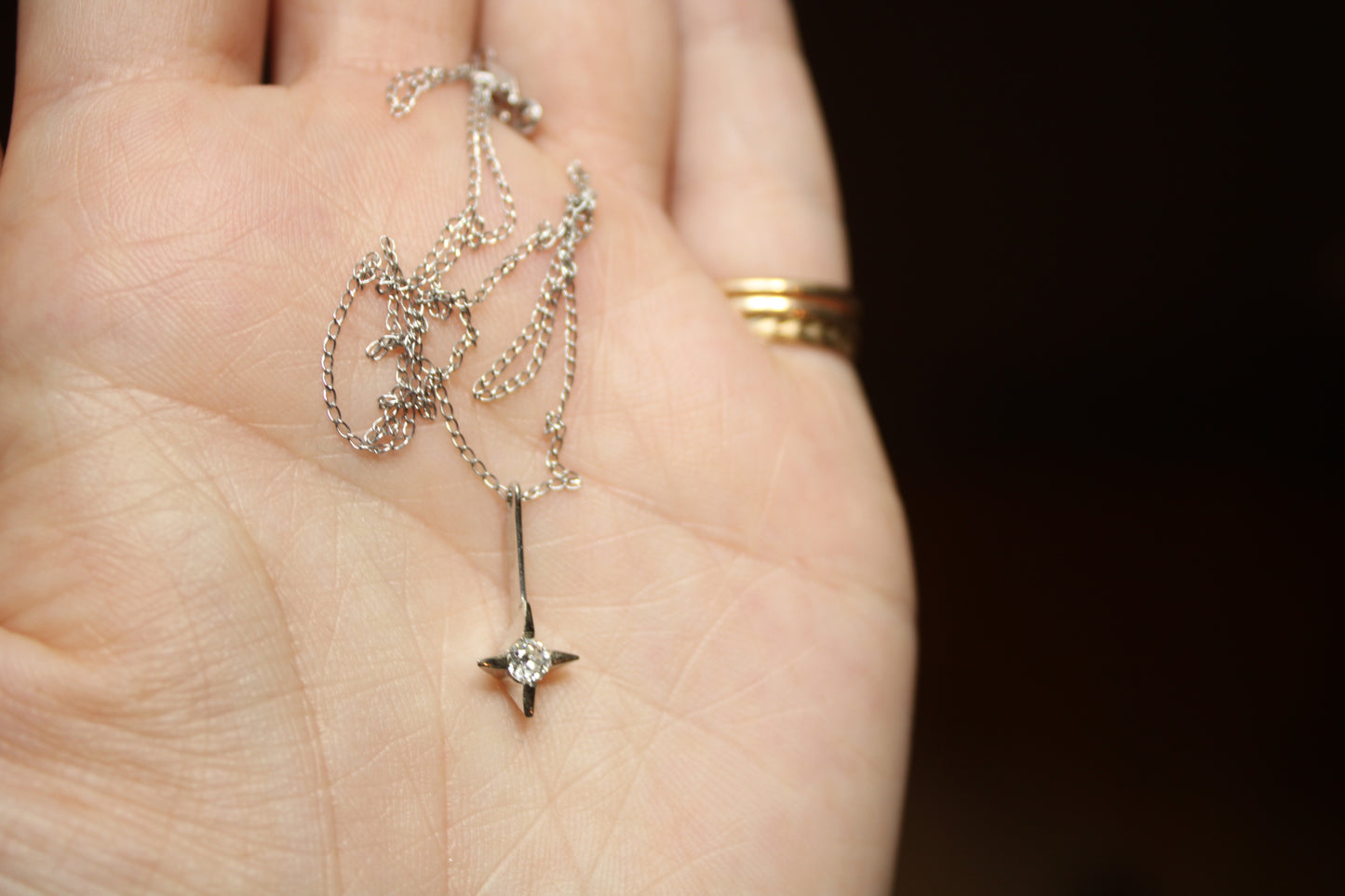 The *only* white gold necklace I have in my current collection. This beautifully delicate cable chain is balanced with an expertly set colorless CZ pendant.  Details: - process: I found this chain as part of an estate sale I was exploring.  - materials: 14k solid white gold (hallmarked) + CZ pendant (20mm long x 5mm wide)