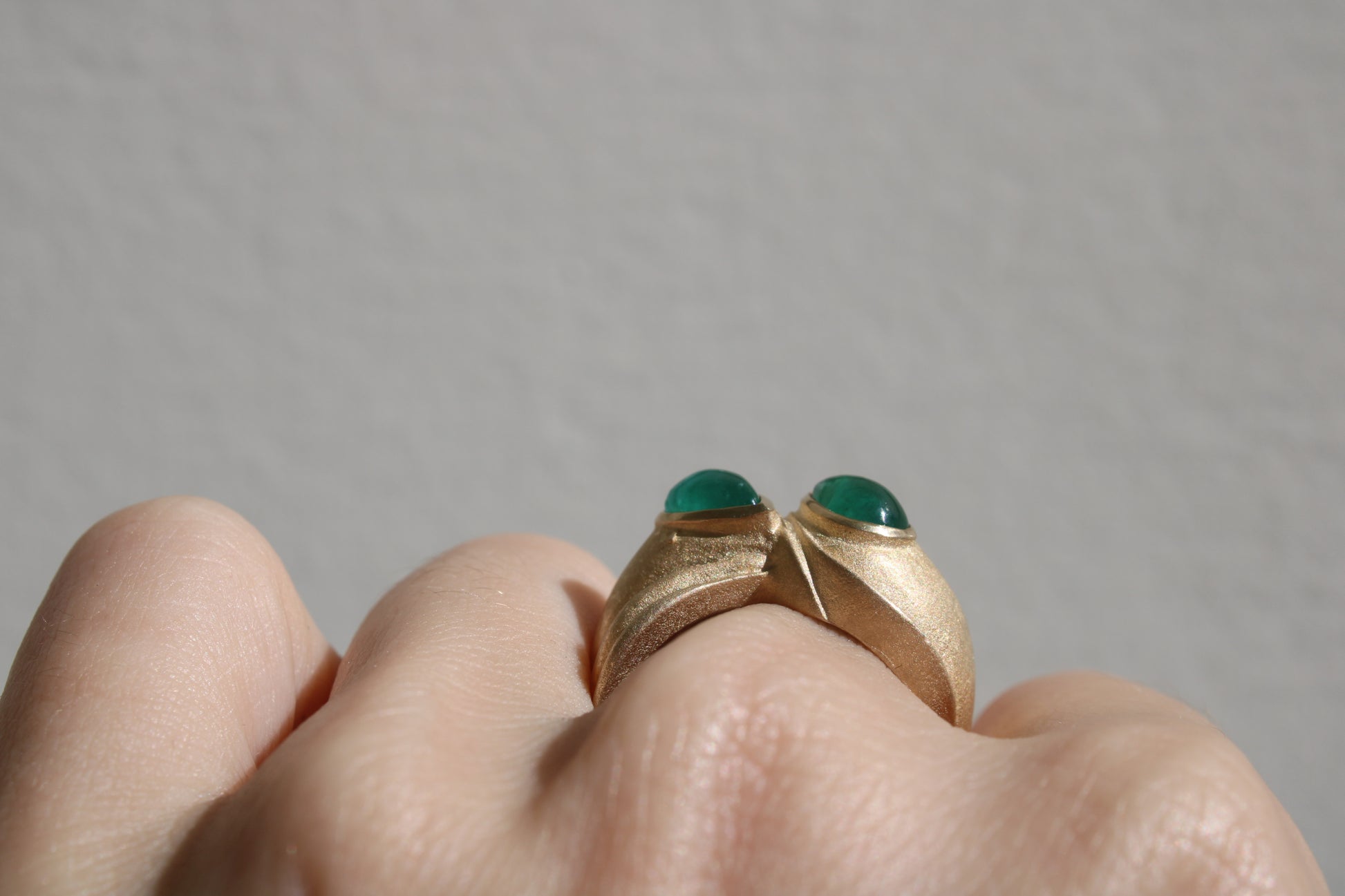 Toi et moi rings: the most romantic of rings. Symbolizing two parts of a whole, or symbolizing the interconnected nature of our internal tensions. I think there's something scared about this type of interlocking geometry and there's an infinite world of glamour inside of this specific form.&nbsp; Natural Colombian emeralds nestled in nearly raw recycled 10k gold are pictured.
