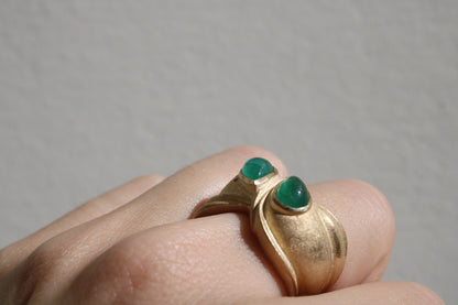 Toi et moi rings: the most romantic of rings. Symbolizing two parts of a whole, or symbolizing the interconnected nature of our internal tensions. I think there's something scared about this type of interlocking geometry and there's an infinite world of glamour inside of this specific form.&nbsp; Natural Colombian emeralds nestled in nearly raw recycled 10k gold are pictured.