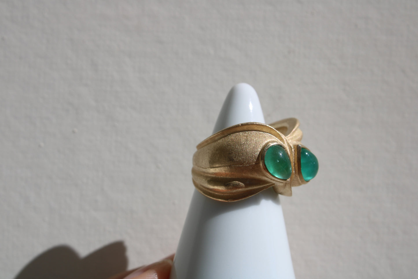 Toi et moi rings: the most romantic of rings. Symbolizing two parts of a whole, or symbolizing the interconnected nature of our internal tensions. I think there's something scared about this type of interlocking geometry and there's an infinite world of glamour inside of this specific form.&nbsp; Natural Colombian emeralds nestled in nearly raw recycled 10k gold are pictured.