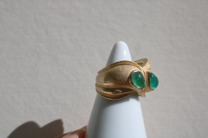 Toi et moi rings: the most romantic of rings. Symbolizing two parts of a whole, or symbolizing the interconnected nature of our internal tensions. I think there's something scared about this type of interlocking geometry and there's an infinite world of glamour inside of this specific form.&nbsp; Natural Colombian emeralds nestled in nearly raw recycled 10k gold are pictured.
