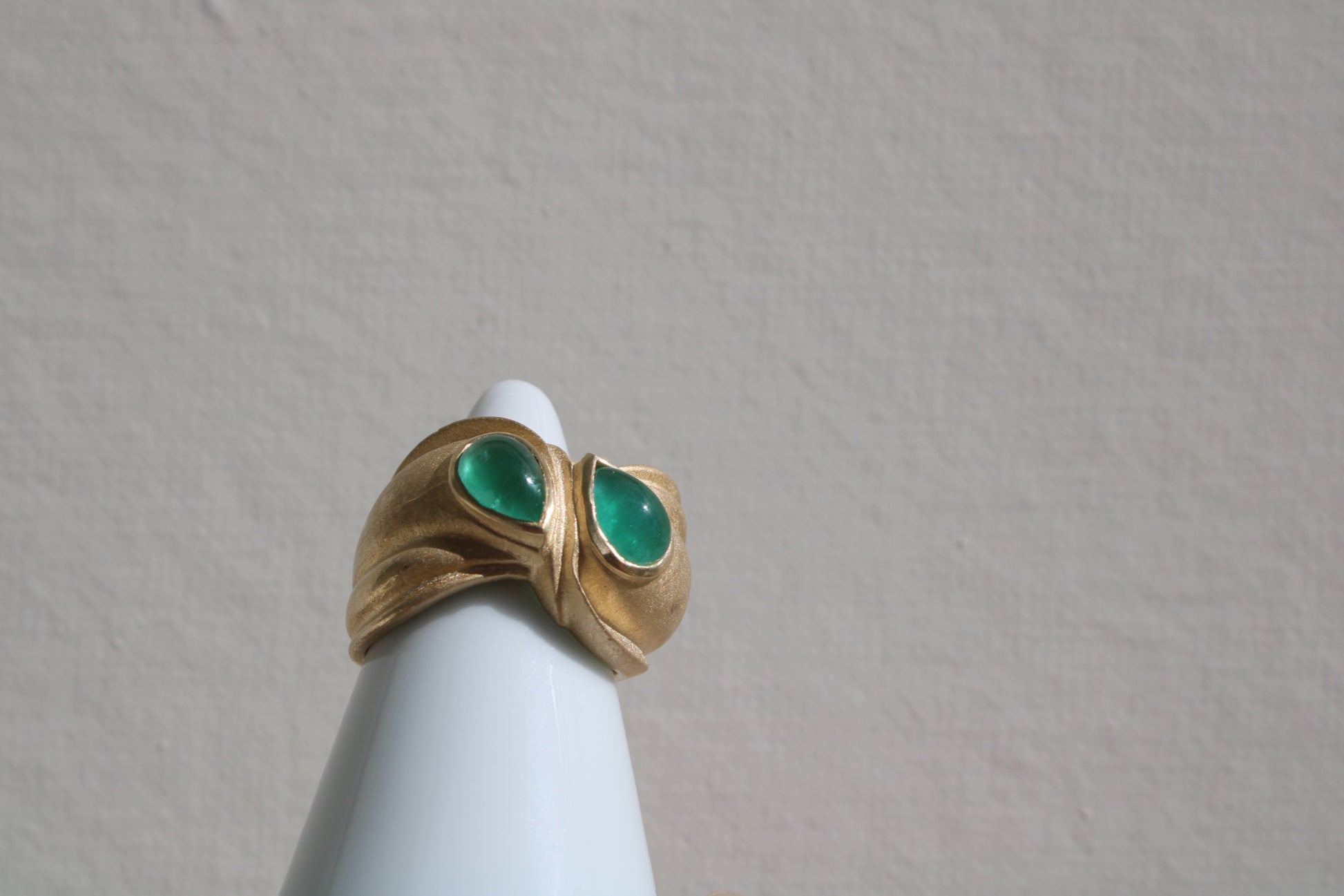 Toi et moi rings: the most romantic of rings. Symbolizing two parts of a whole, or symbolizing the interconnected nature of our internal tensions. I think there's something scared about this type of interlocking geometry and there's an infinite world of glamour inside of this specific form.&nbsp; Natural Colombian emeralds nestled in nearly raw recycled 10k gold are pictured.