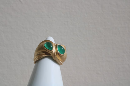 Toi et moi rings: the most romantic of rings. Symbolizing two parts of a whole, or symbolizing the interconnected nature of our internal tensions. I think there's something scared about this type of interlocking geometry and there's an infinite world of glamour inside of this specific form.&nbsp; Natural Colombian emeralds nestled in nearly raw recycled 10k gold are pictured.