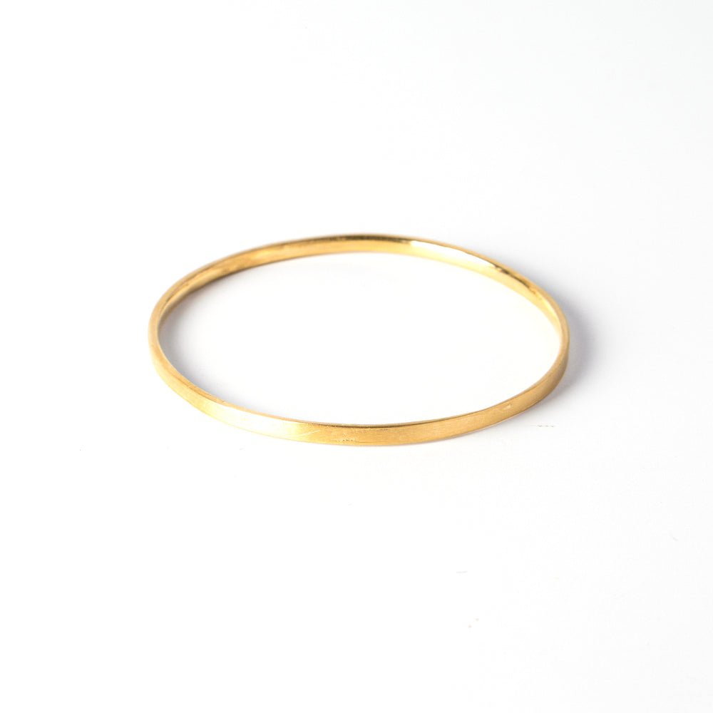 A durable and ergonomic yet elegant solid gold bangle.   I love knowing about jewelry history and the bangle is one of the oldest, most simple yet elegant and nuanced forms of adornment. The word bangle was derived from the traditional Sanskrit word Bangri or Bangali -&nbsp;the ornament that adorns the arm.&nbsp;