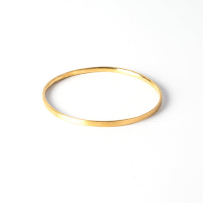 A durable and ergonomic yet elegant solid gold bangle.   I love knowing about jewelry history and the bangle is one of the oldest, most simple yet elegant and nuanced forms of adornment. The word bangle was derived from the traditional Sanskrit word Bangri or Bangali -&nbsp;the ornament that adorns the arm.&nbsp;