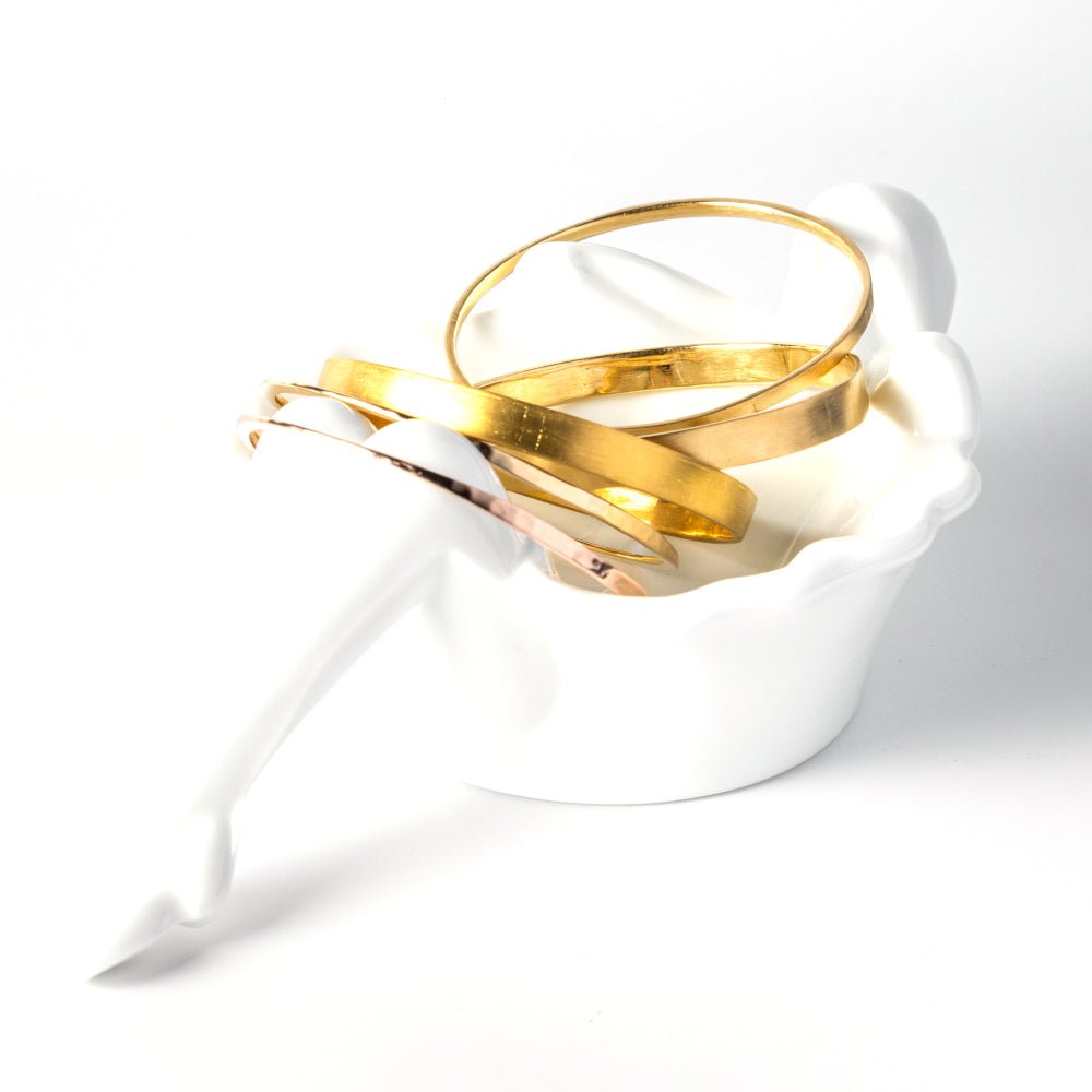 A durable and ergonomic yet elegant solid gold bangle.   I love knowing about jewelry history and the bangle is one of the oldest, most simple yet elegant and nuanced forms of adornment. The word bangle was derived from the traditional Sanskrit word Bangri or Bangali -&nbsp;the ornament that adorns the arm.&nbsp;