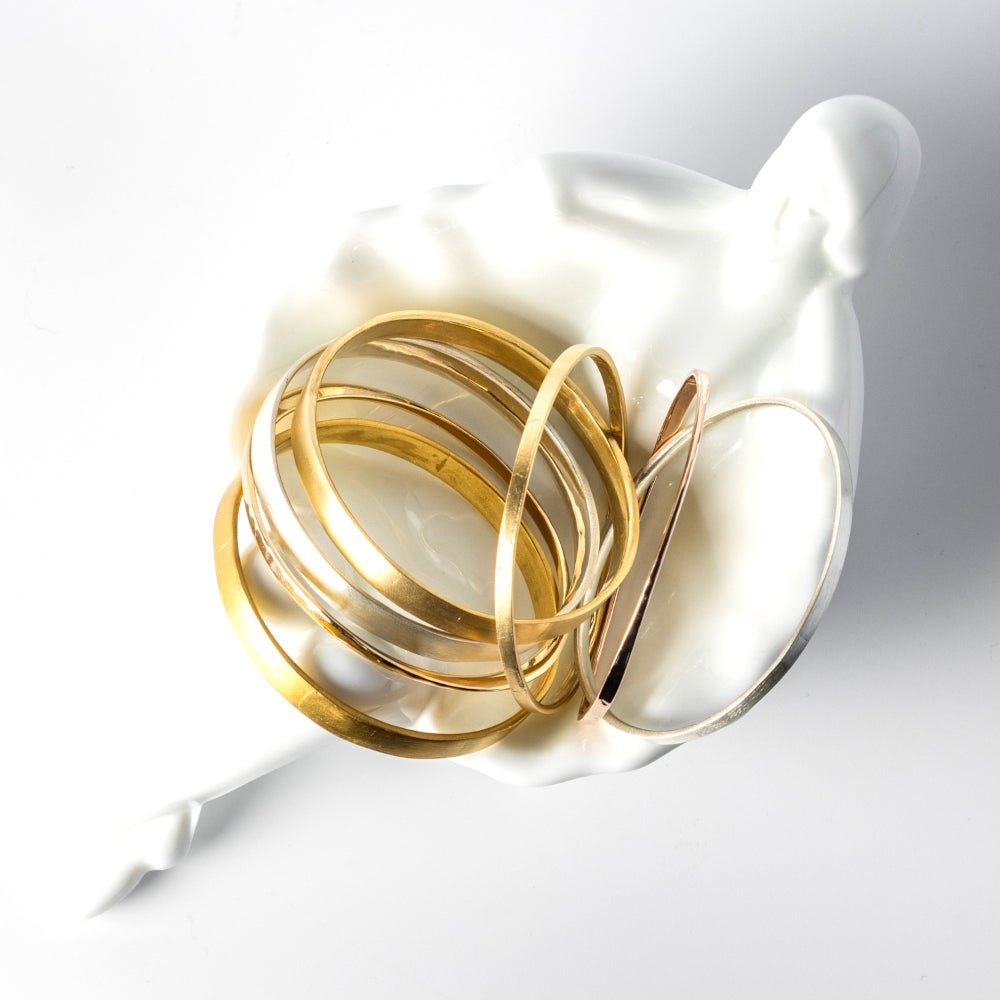 A durable and ergonomic yet elegant solid gold bangle.   I love knowing about jewelry history and the bangle is one of the oldest, most simple yet elegant and nuanced forms of adornment. The word bangle was derived from the traditional Sanskrit word Bangri or Bangali -&nbsp;the ornament that adorns the arm.&nbsp;
