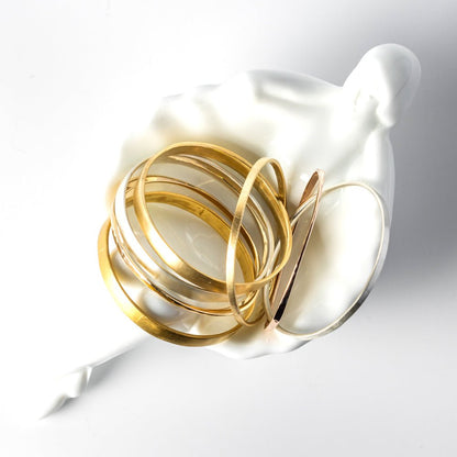 A durable and ergonomic yet elegant solid gold bangle.   I love knowing about jewelry history and the bangle is one of the oldest, most simple yet elegant and nuanced forms of adornment. The word bangle was derived from the traditional Sanskrit word Bangri or Bangali -&nbsp;the ornament that adorns the arm.&nbsp;
