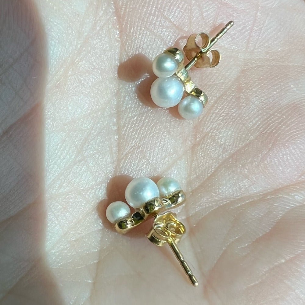 Six lustrous freshwater cultured pearls set in 14k gold. The largest pearl is 4mm and is hugged by two 3mm pearls. Earring posts have two friction groves to provide extra security and durability to hold the earring backs in place.